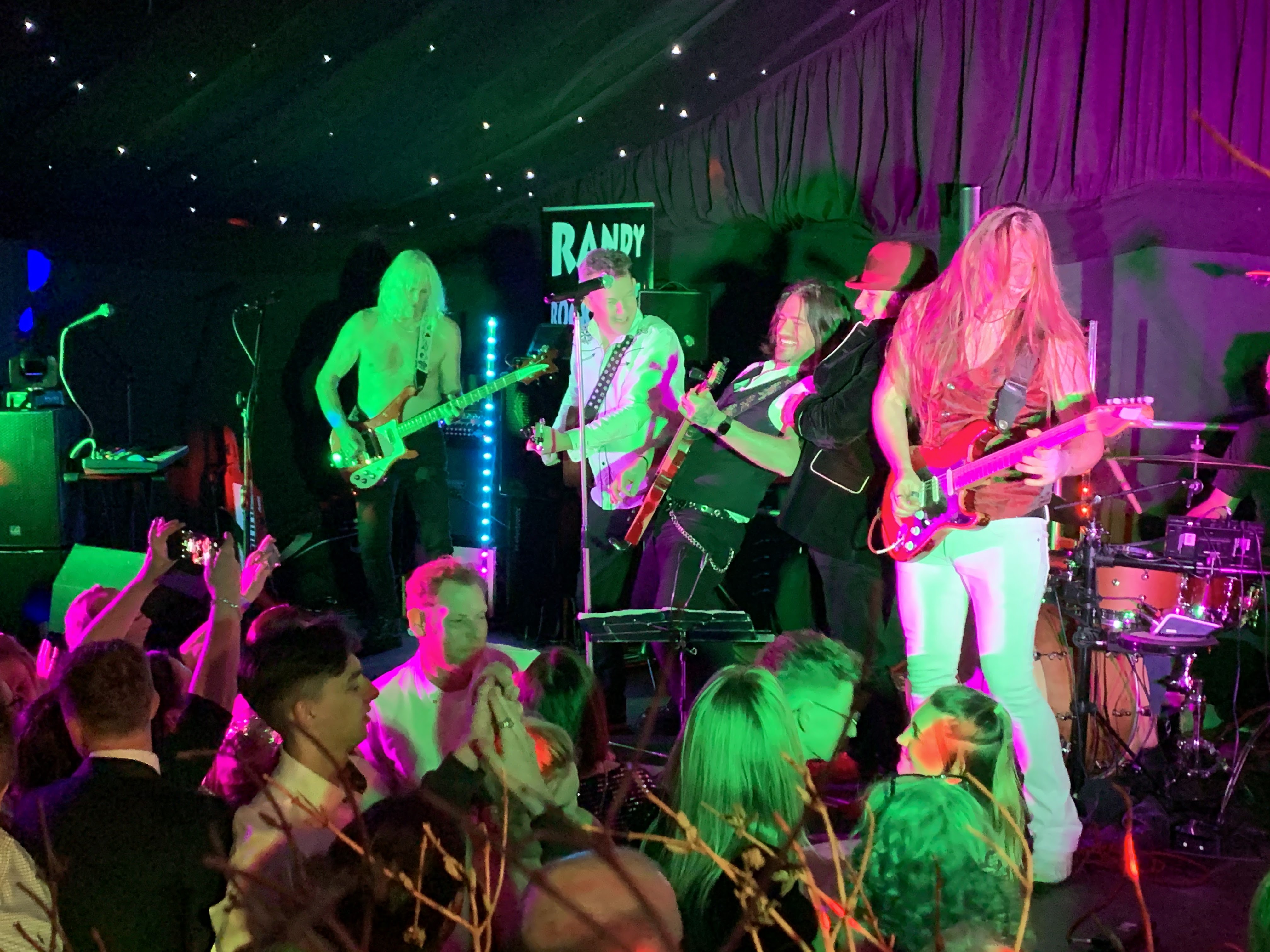 A live band playing in the marquee with a dancing crowd